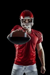 American football player showing ball