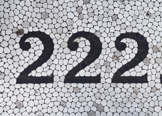 The number two hundred and twenty two in black on white tile - 89511958