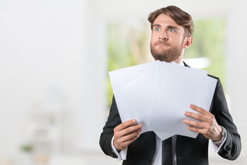 Businessman confused with a lot of paperwork