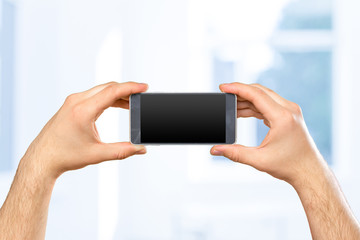 Man's hand holding smartphone