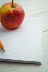 View of an apple and notepad