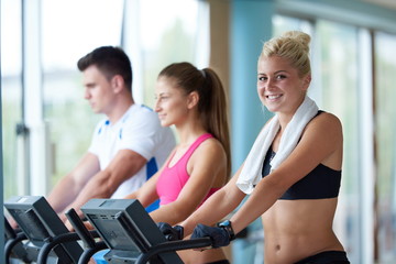 Fototapeta premium friends exercising on a treadmill at the bright modern gym