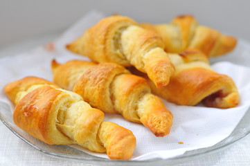 Freshly baked croissants on white napkin