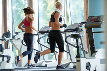 Fototapeta na wymiar woman exercising on treadmill in gym