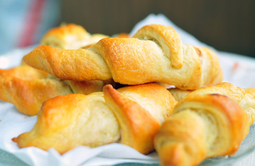 Freshly baked croissants on white napkin