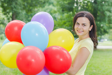 Fototapeta na wymiar Happy Young Woman With Colorful Balloons