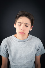 Handsome boy doing different expressions in different sets of clothes: sad