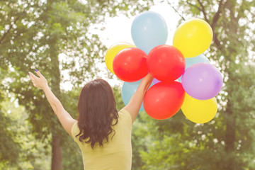 Happy Young Woman With Colorful Balloons