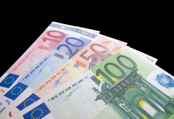 Various euro notes isolated on black background