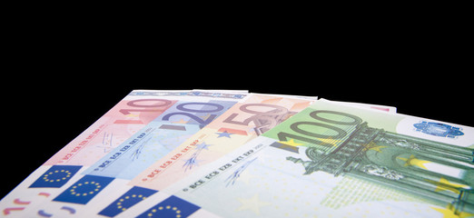 Various euro notes isolated on black background