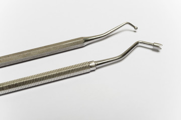 Chromed dental equipment on a blank white background. Two different ends of the dental tools.