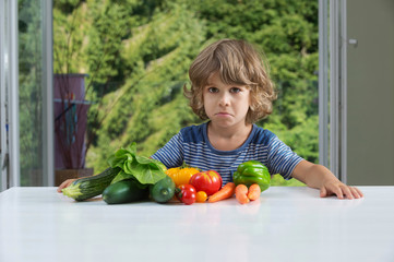 Fototapeta premium Little boy vegetable meal