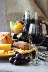 Fototapeta na wymiar Still life with fruit, a plate of cheese and a glass of wine..