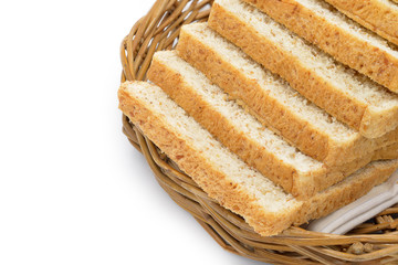 Closeup whole wheat bread in a rattan basket, isolated on white background