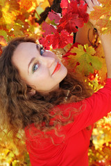 Pretty Girl with curly shiny hair in yellow grape vineyard