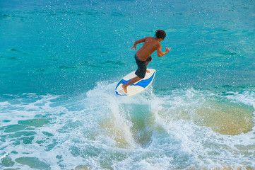 Teenage boy skimboarding on Maui, Hawaii, USA