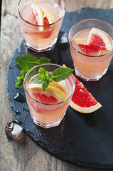 Pink cocktail with ice and mint