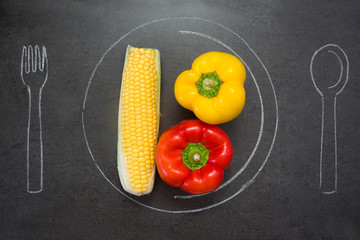 Corn and peppers on slate table