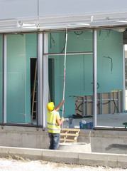 Worker painting metal bars