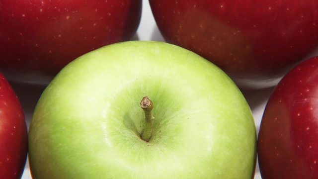 Red apples with one green apple