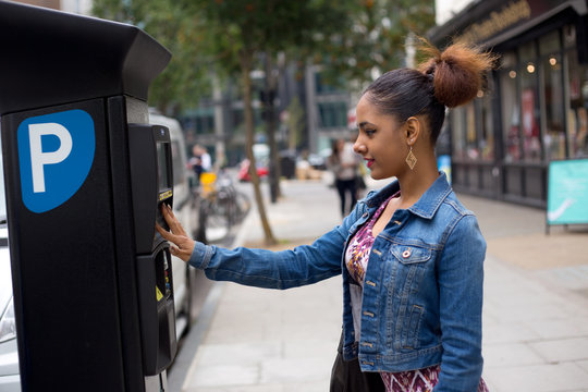 Young Woman Paying Her Parking Ticket