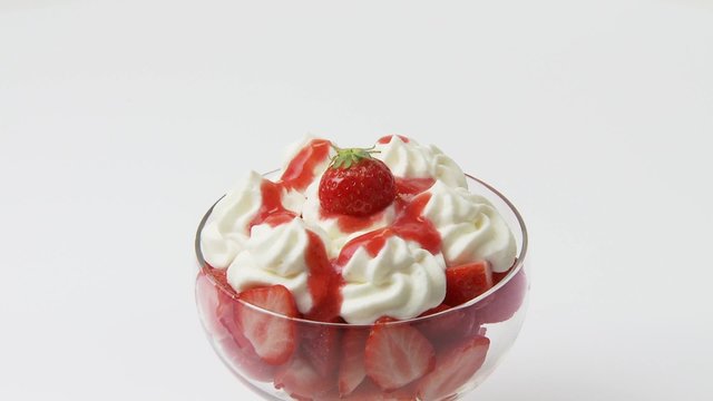 Fresh strawberries with cream in a dessert glass