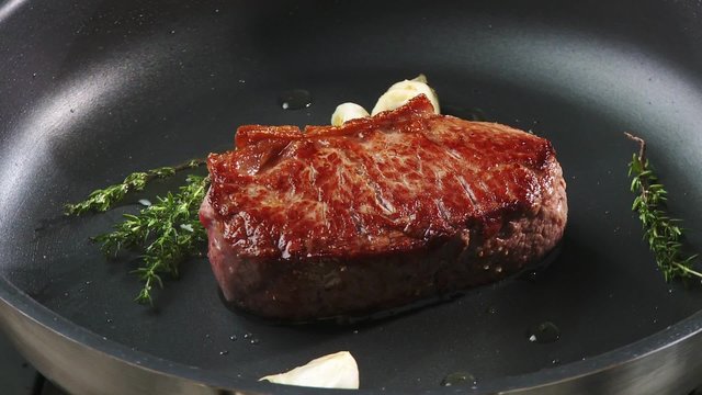 Frying beef sirloin in a frying pan