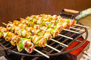 BBQ barbecuing skewers, grill with vegetable skewer - close up.
