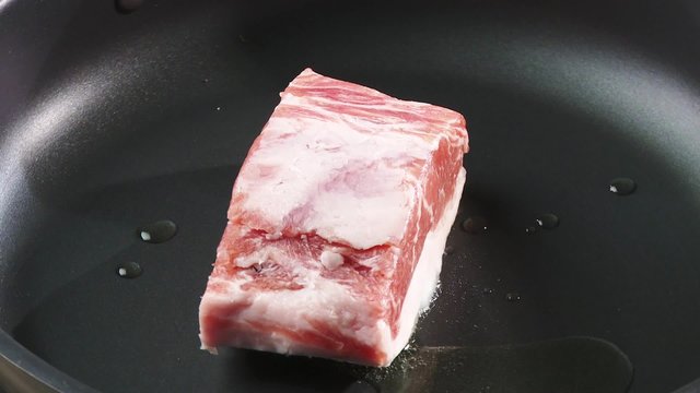 Frying loin of Iberian pork in a frying pan