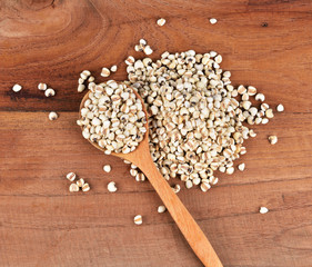 Obraz na płótnie Canvas millet grain on wood background.