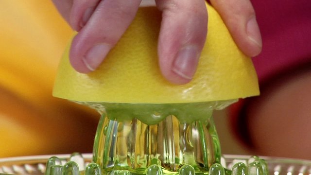 Squeezing a grapefruit (close-up)
