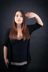 Beautiful woman doing different expressions in different sets of clothes: at attention