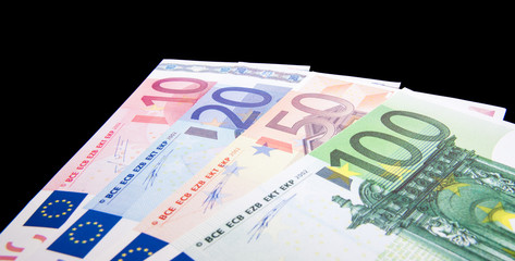 Various euro notes isolated on black background