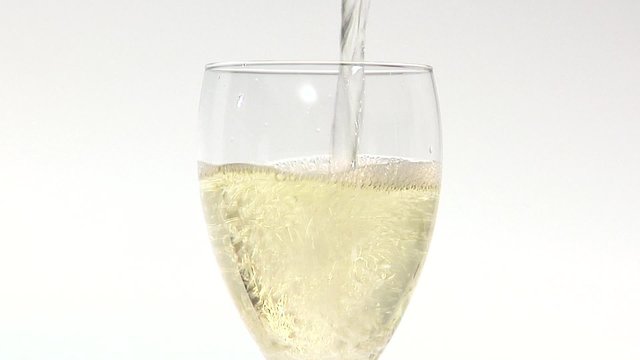 Pouring a glass of white wine (close-up)