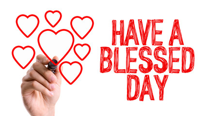 Hand with marker writing the word Have a Blessed Day