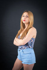 Beautiful girl doing different expressions in different sets of clothes: arms crossed