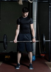 Fototapeta na wymiar Athlete Fitness trainer working out / weight lifting in a gym
