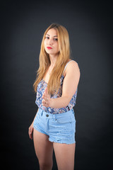 Naklejka premium Beautiful girl doing different expressions in different sets of clothes: gun sign