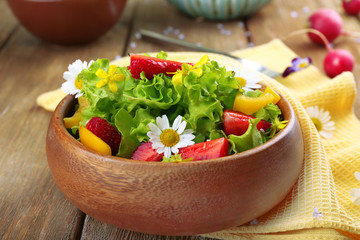 Light organic salad with flowers, close up