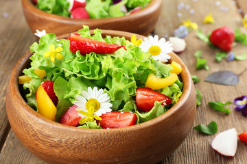 Light organic salad with flowers, close up