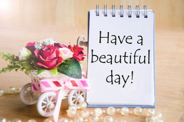 Have a nice day on open diary and and red rose.