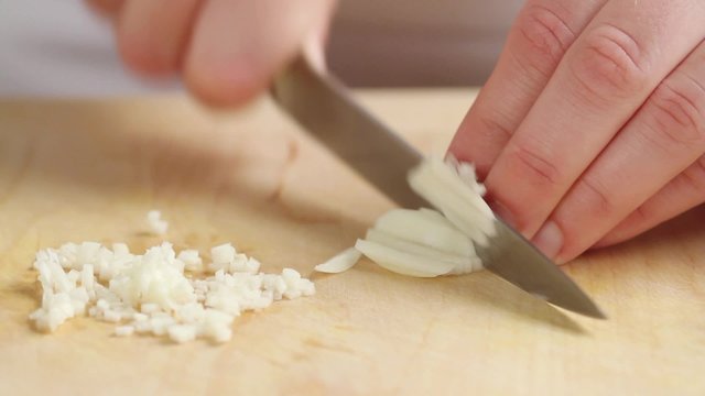 Chopping garlic cloves finely