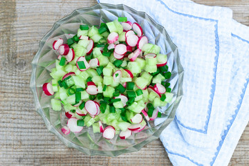 Fresh spring salad with cucumbers, green onion and radish
