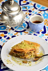 traditional Turkish arabic dessert - baklava with honey and pistachios