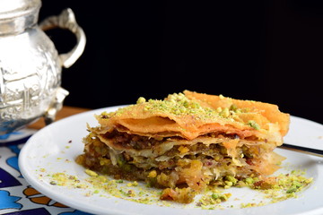 traditional Turkish arabic dessert - baklava with honey and pistachios