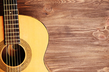 Obraz premium Acoustic guitar on wooden background