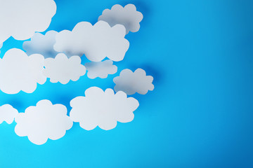 White paper clouds on blue background. Cloud computing concept.