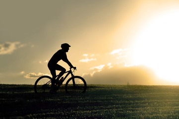 Fototapeta premium profile silhouette sport man riding cross country mountain bike