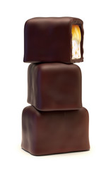 Chocolate candies with caramel filling, nougat and nuts crumb. Isolated on white background.