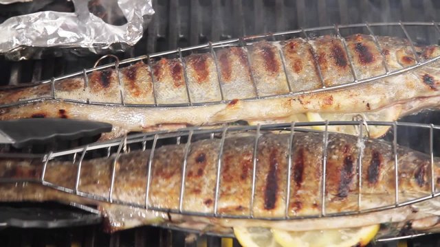 Trout being grilled in fish baskets